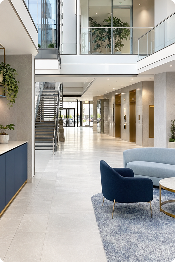 Modern multi-story commercial office building lobby with elevators and lounge seating maintained by Westline Facilities commercial cleaning services.