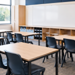 Clean, tidy school classroom with desks, chairs and whiteboard, maintained by Westline Facilities in London